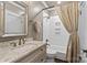 Bathroom showcasing marble countertop vanity, tile backsplash and bathtub shower with curtain at 413 E Worthington Ave, Charlotte, NC 28203