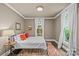 Bedroom with ample natural light, a metal bed frame, an area rug and two pieces of art at 413 E Worthington Ave, Charlotte, NC 28203