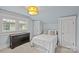 Comfortable bedroom features a plush bed, dresser, and a large window for natural light at 413 E Worthington Ave, Charlotte, NC 28203