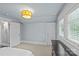 Spacious bedroom with two closets, a dresser, and bright light fixture at 413 E Worthington Ave, Charlotte, NC 28203