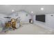 Bonus room featuring a drumset, guitar and mounted tv with neutral carpet at 413 E Worthington Ave, Charlotte, NC 28203
