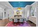 Elegant dining room features a blue ceiling, modern chandelier, and stylish decor at 413 E Worthington Ave, Charlotte, NC 28203