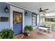Welcoming front porch with a stained wood floor, white bench seating, plants, and decorative lighting at 413 E Worthington Ave, Charlotte, NC 28203