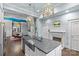 Open kitchen design with stainless steel appliances, island with seating, and nearby dining space at 413 E Worthington Ave, Charlotte, NC 28203