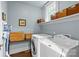 Functional laundry room includes washer, dryer, shelving and storage baskets at 413 E Worthington Ave, Charlotte, NC 28203