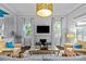 Comfortable living room with a fireplace, large windows, stylish furnishings, and a decorative ceiling light fixture at 413 E Worthington Ave, Charlotte, NC 28203