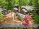 Lakefront home with an inviting outdoor space, including a fire pit, landscaping, and parking at 449 Windward Dr, Davidson, NC 28036