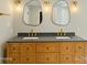 Modern bathroom featuring a dual sink vanity, unique light fixtures and plenty of drawer space at 449 Windward Dr, Davidson, NC 28036