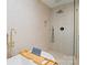 Modern bathroom featuring soaking tub with gold fixtures and glass enclosed shower with black trim at 449 Windward Dr, Davidson, NC 28036