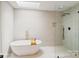 Bright bathroom with a freestanding tub, skylight, and a walk-in shower with glass enclosure at 449 Windward Dr, Davidson, NC 28036