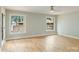 Large bedroom with hardwood floors, neutral paint, and large picture windows overlooking a lake at 449 Windward Dr, Davidson, NC 28036