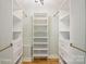 Walk-in closet offers custom shelving, drawers, and brass rods at 449 Windward Dr, Davidson, NC 28036