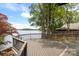 Spacious deck overlooking a serene lake view surrounded by lush trees in a tranquil setting at 449 Windward Dr, Davidson, NC 28036