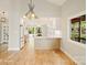 Open dining area flows into a modern kitchen with white cabinets, stainless appliances, and hardwood floors at 449 Windward Dr, Davidson, NC 28036