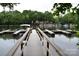 Picturesque dock with multiple boat slips offering direct access to a tranquil lake surrounded by lush trees at 449 Windward Dr, Davidson, NC 28036