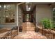 Charming entrance with brick steps, wrought iron railings, and a striking front door at 449 Windward Dr, Davidson, NC 28036