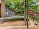 Lakeside house with a deck, mature trees, and lush landscaping at 449 Windward Dr, Davidson, NC 28036