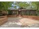 Welcoming facade showcases a brick-accented driveway, mature trees, and inviting front entrance at 449 Windward Dr, Davidson, NC 28036