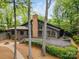Contemporary exterior featuring a brick chimney, extensive deck, and manicured landscaping at 449 Windward Dr, Davidson, NC 28036