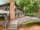 Lakeside house featuring a spacious deck with views of the water and wooded surroundings at 449 Windward Dr, Davidson, NC 28036