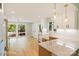 Open kitchen layout with marble countertops, farmhouse sink, stainless appliances and a view to the backyard at 449 Windward Dr, Davidson, NC 28036