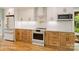 Modern kitchen featuring stainless appliances, custom cabinets, and a stylish backsplash and ample storage at 449 Windward Dr, Davidson, NC 28036