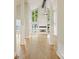 Bright, airy living room features soaring ceilings, fireplace, and expansive windows with water views at 449 Windward Dr, Davidson, NC 28036