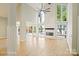 Spacious living room featuring tall ceilings, fireplace, and sliding glass doors to a deck with water views at 449 Windward Dr, Davidson, NC 28036