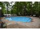 Relaxing pool area surrounded by lounge chairs and lush greenery, offering a perfect spot for leisure at 449 Windward Dr, Davidson, NC 28036