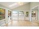 Bright sunroom showcases beautiful windows offering serene views of the lake and outdoor deck access at 449 Windward Dr, Davidson, NC 28036