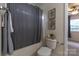 Cozy bathroom with shower/tub combo, and decorative artwork with tranquil natural light at 4637 Willow Glen Rd, Harrisburg, NC 28075