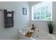Bright tub featuring built-in jets, gold fixtures, and decor at 4637 Willow Glen Rd, Harrisburg, NC 28075
