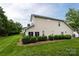 Well-maintained exterior with large manicured lawn and mature trees provide a lush backdrop at 4637 Willow Glen Rd, Harrisburg, NC 28075