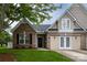 Charming two-story home with a brick facade, manicured lawn, and a welcoming front entrance at 4637 Willow Glen Rd, Harrisburg, NC 28075