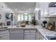 Bright kitchen with granite countertops and stainless steel appliances overlooks the living room with fireplace at 4637 Willow Glen Rd, Harrisburg, NC 28075
