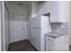 Efficient kitchen with white cabinets, stainless steel refrigerator, and access to outdoor entry at 4637 Willow Glen Rd, Harrisburg, NC 28075