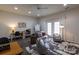 Versatile living area with an abundance of light, stylish decor, and access to the outdoor space at 4637 Willow Glen Rd, Harrisburg, NC 28075