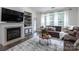 Open-concept living space, fireplace, and comfortable seating with ample natural light and decor at 4637 Willow Glen Rd, Harrisburg, NC 28075