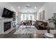 Comfortable open-concept living room, fireplace, and ample seating bathed in natural light at 4637 Willow Glen Rd, Harrisburg, NC 28075