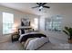 Bright main bedroom featuring a ceiling fan, carpet floors, and windows for natural light at 4637 Willow Glen Rd, Harrisburg, NC 28075