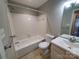 Clean bathroom featuring a tiled shower-tub combo, toilet, and sink with large mirror at 5003 Sharon Rd # Q, Charlotte, NC 28210