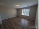 Bedroom featuring wood-look flooring and window with natural light at 5003 Sharon Rd # Q, Charlotte, NC 28210