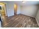 Bedroom with wood-look flooring and adjoining room featuring a sink and mirror at 5003 Sharon Rd # Q, Charlotte, NC 28210