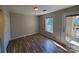 Bedroom showcasing wood-look flooring, window, closet and exterior door to outdoor balcony at 5003 Sharon Rd # Q, Charlotte, NC 28210