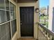 Charming front door with exterior light fixture, railing, and a glimpse of the neighborhood at 5003 Sharon Rd # Q, Charlotte, NC 28210
