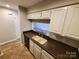 Functional kitchen area featuring laminate counters, white cabinets, and an undermount sink at 5003 Sharon Rd # Q, Charlotte, NC 28210