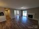 Spacious living room featuring a fireplace, sliding glass doors, and vinyl flooring, seamlessly connecting indoor and outdoor spaces at 5003 Sharon Rd # Q, Charlotte, NC 28210