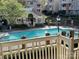 View of the fenced community pool and pool house at 5003 Sharon Rd # Q, Charlotte, NC 28210