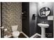 Stylish powder room with black and white patterned wallpaper, modern fixtures, and unique decor, providing elegance at 5113 Saddleback Dr, Mount Holly, NC 28120