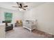Cozy Bedroom featuring a crib, chair, shelving and a bright window at 5113 Saddleback Dr, Mount Holly, NC 28120